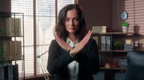 Businesswoman Gestures 'No' in an Office Setting