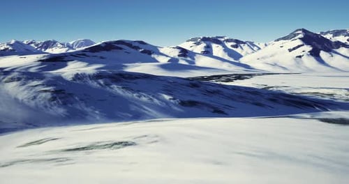 Flying Over Majestic Snowy Mountain Landscape