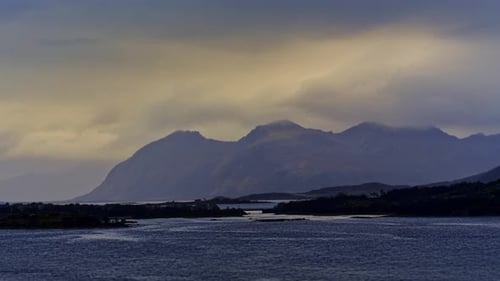 Stream surrounded by mountains in a windy autumn afternoon. Lofoten Islands, Northern Norway.