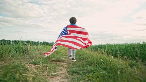 Child Runs With American Flag in Field