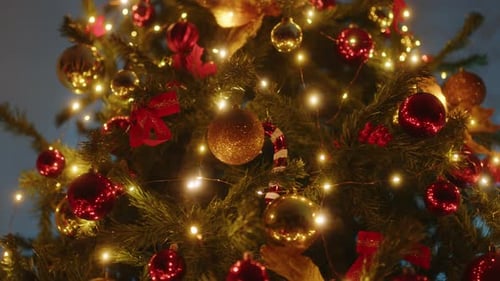 Christmas Tree with Golden and Red Balls in the Night and Nutcracker
