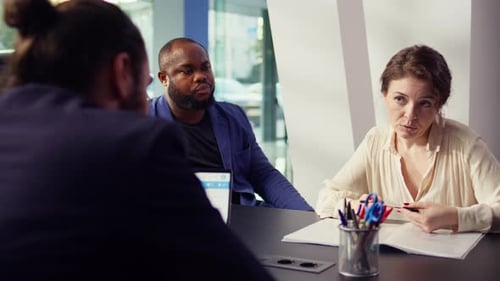 Client in Car Showroom Deliberating Purchase Negotiating with Salesperson