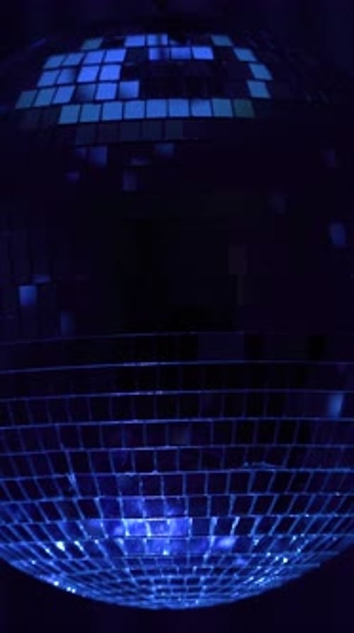 Dance party decoration with shimmering disco ball. Vertical