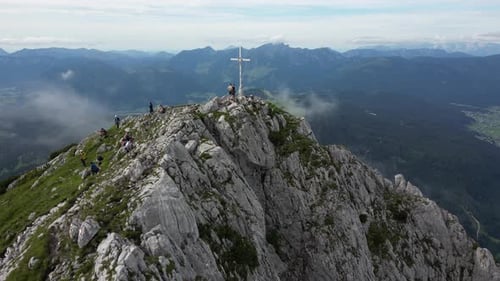 Aerial Footage of the Mountain Top with a Cross Tourists Walking Scenic