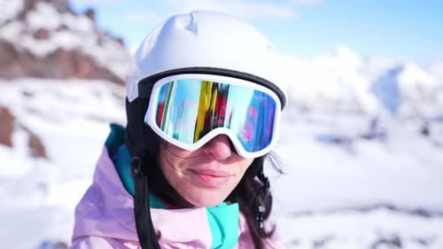Woman in Ski Gear on Snowy Mountain