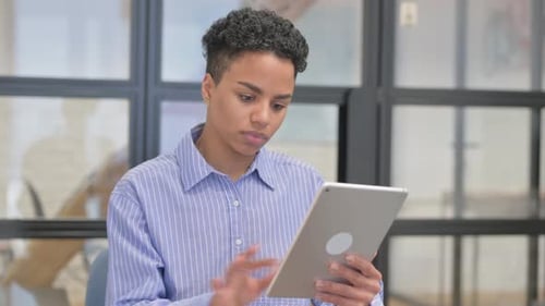 Woman using silver tablet in office