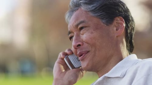 Senior Asian Man Talking On Cell Phone
