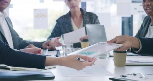 4k video footage of a group of businesspeople using a digital tablet during a meeting in an office