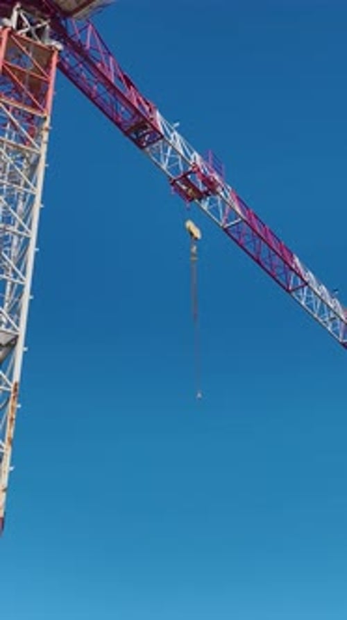 Vertical Video of Residential Construction With Active Crane Work and Concrete Pouring Operations