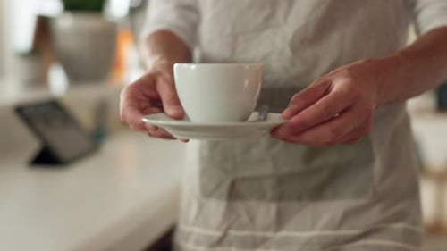Service, cafe and waiter with a coffee for a customer, serving a drink and giving an order