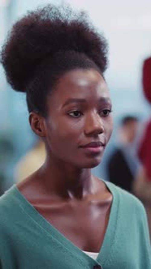 A Woman in a Green Cardigan Captivates with Her Warm Smile