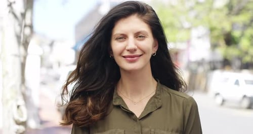 4k video footage of a young woman smiling while out in the city