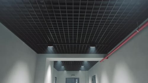 Rear Camera Movement in a Dark Corridor with a View of the Ceiling