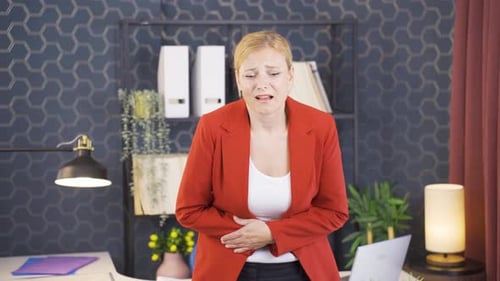 Woman experiencing stomachache.
