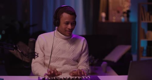 A Musician Passionately Creating Unique Beats in a Cozy and Inviting Studio Environment