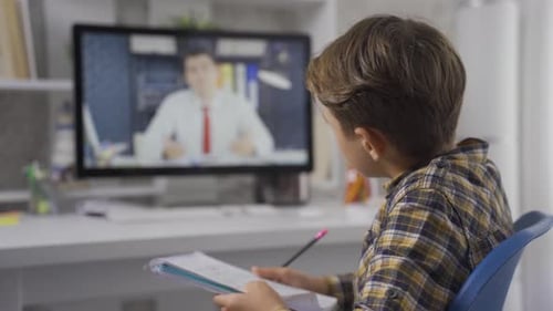 Child Engaged in Online Lesson at Home