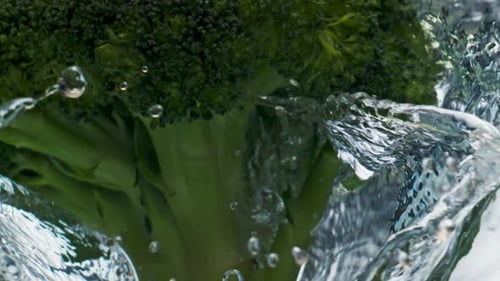 Closeup Broccoli Dropping Water Surface Closeup. Healthy Green Vegetable Splash Falling Liquid
