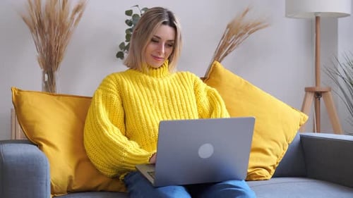 Woman Working on Laptop Computer at Home