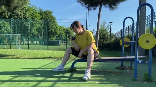 A Female Athlete Works Out at the Sport Area in the Morning