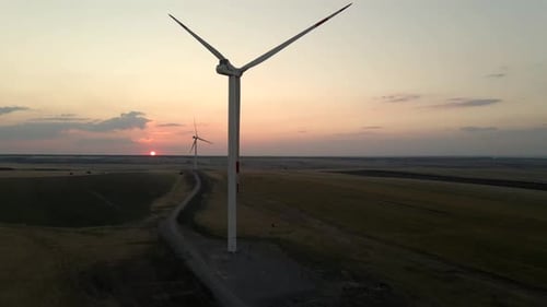 Windmills Generate Electric Power at Sunset in a Serene Windmill Park Highlighting Green Energy