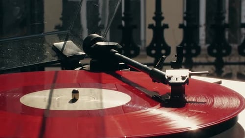 Red Vinyl Record Spinning on a Vintage Player