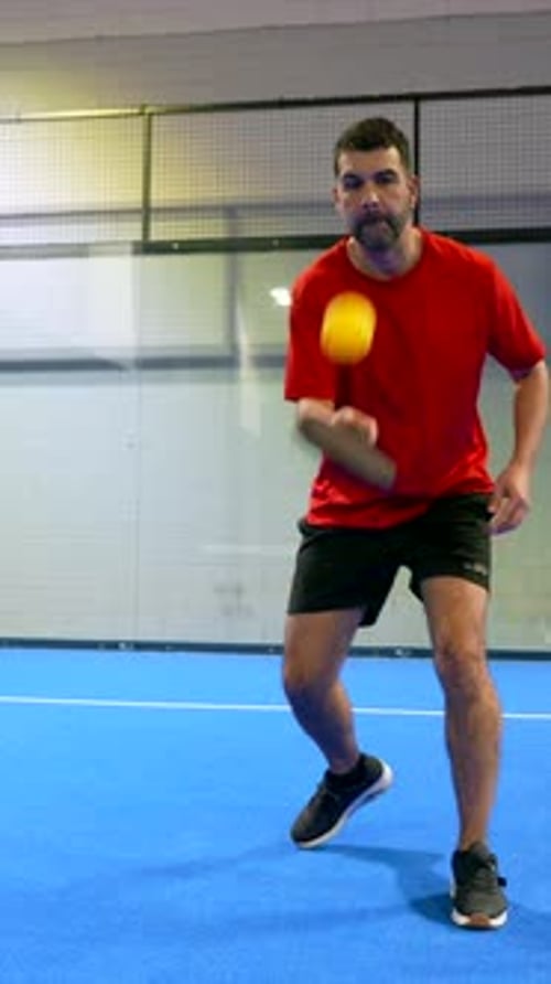 Men Play Padel Tennis Match on Blue Court