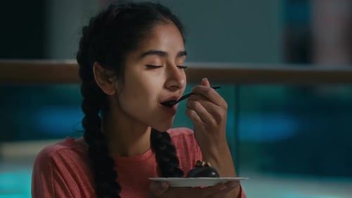 Woman Enjoys a Decadent Chocolate Dessert