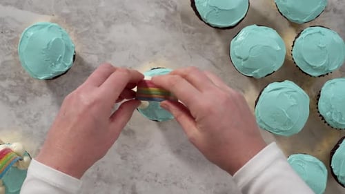 Flat Lay Decorating Chocolate Cupcakes with Buttercream Frosting and Rainbow Candy