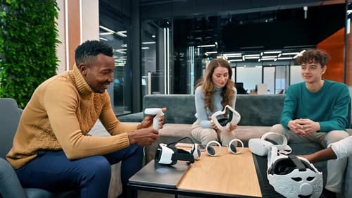 Business conference in VR in an office. Multiracial group of people holding and talking about VR gla