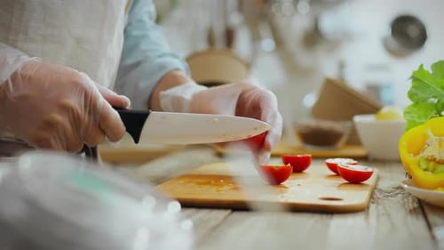 Person Cuts Tomatoes in Bright Kitchen