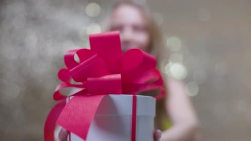 Woman Receives Gift Box with Pink Bow