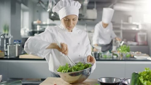 In a Famous Restaurant Female Cook Prepares Salad. She Works in a Big Modern Kitchen.
