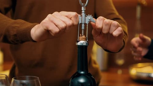 Uncorking a Bottle with a Classic Corkscrew in an Elegant Bar Setting