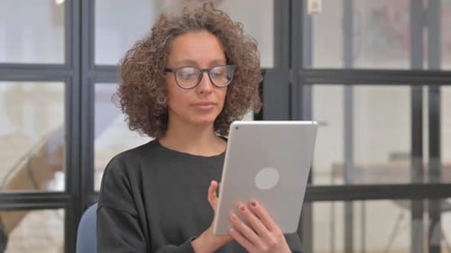 Woman Uses Tablet Device in Office