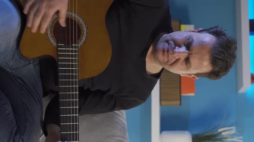 Man Plays Acoustic Guitar Indoors