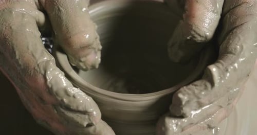 Hands Shaping Clay Bowl on Pottery Wheel