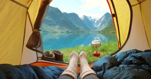 Feet, camping tent and relax on vacation, travel and mountain view on morning in nature