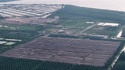 Aerial view of solar panel farm and coastline