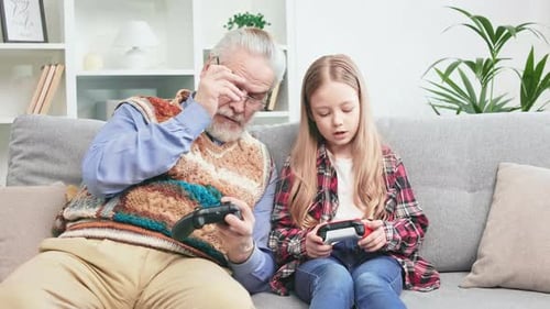 Grandfather and Granddaughter Play Video Games Together