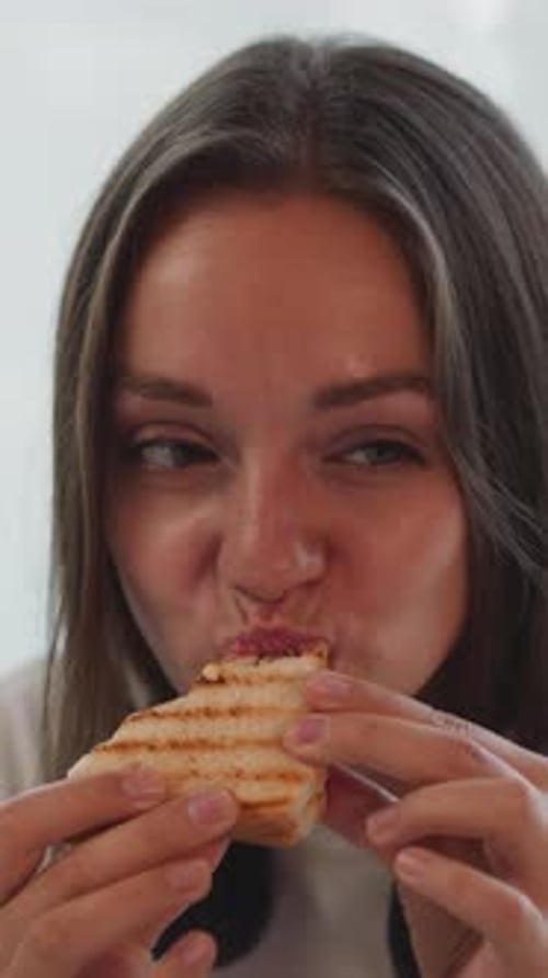 Hungry Brunette Woman Bites Cheese Sandwich Wiping Lips