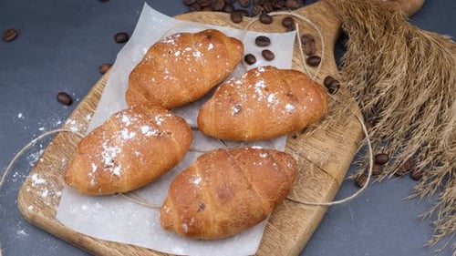 Fresh Croissants with Coffee Beans on a Board