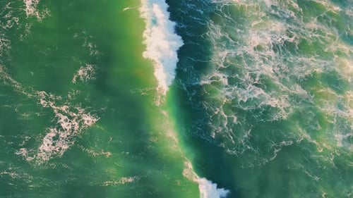 Top view stormy sea surface waving with white foam in super slow motion
