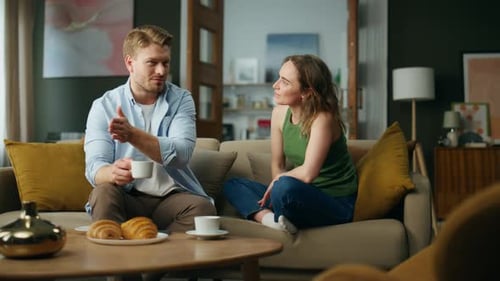 Chilling Spouses Drinking Tea at Sofa Interior. Love Couple Enjoying Coffee Cups