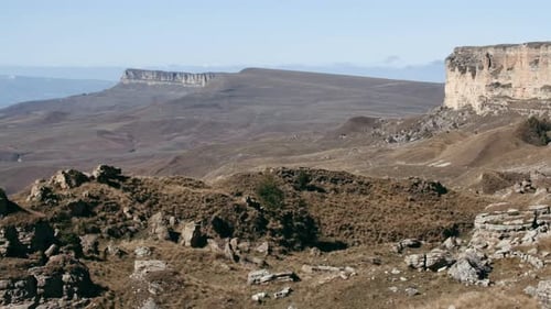 Beautiful sunny valley with rock formations and mountains