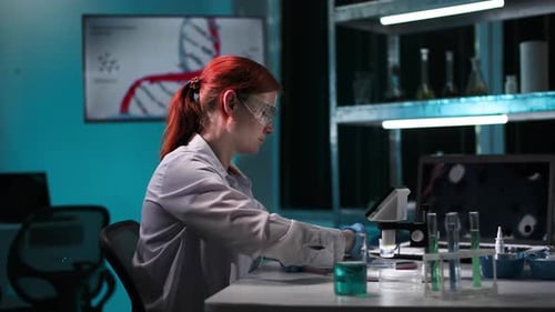 Scientist Working in Lab with Microscope and Test Tubes