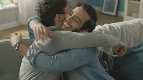 Loving Couple Embrace on Sofa Indoors