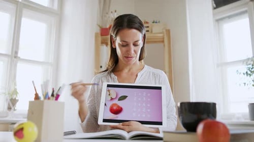 Enthusiastic Woman Teaches Math Concepts Online with Tablet