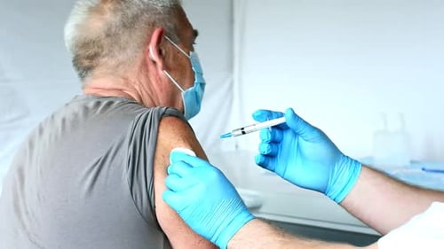 Adult Receives Injection From Health Professional