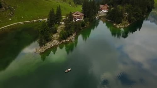 boat rowing in a beautiful calm lake surrounded by allot of green clear water