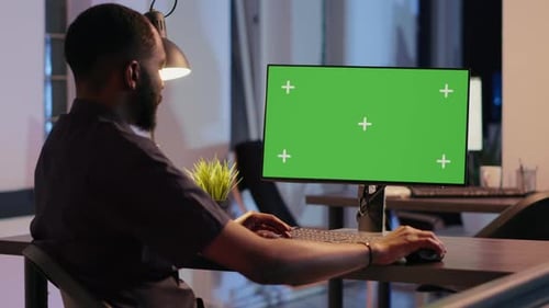 Office Employee Working with Greenscreen Display on Computer